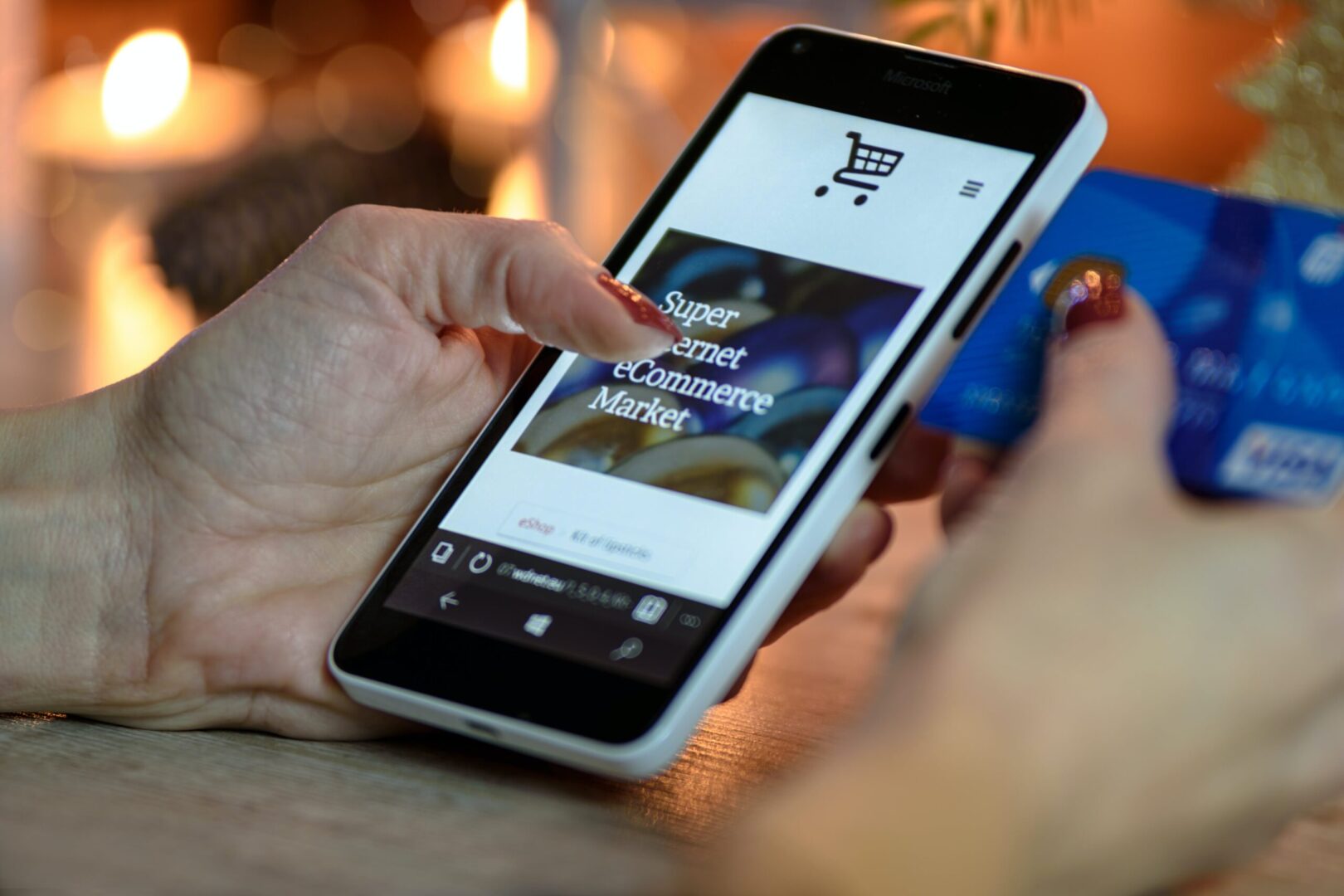 A person is holding an iphone with the shopping cart on it.