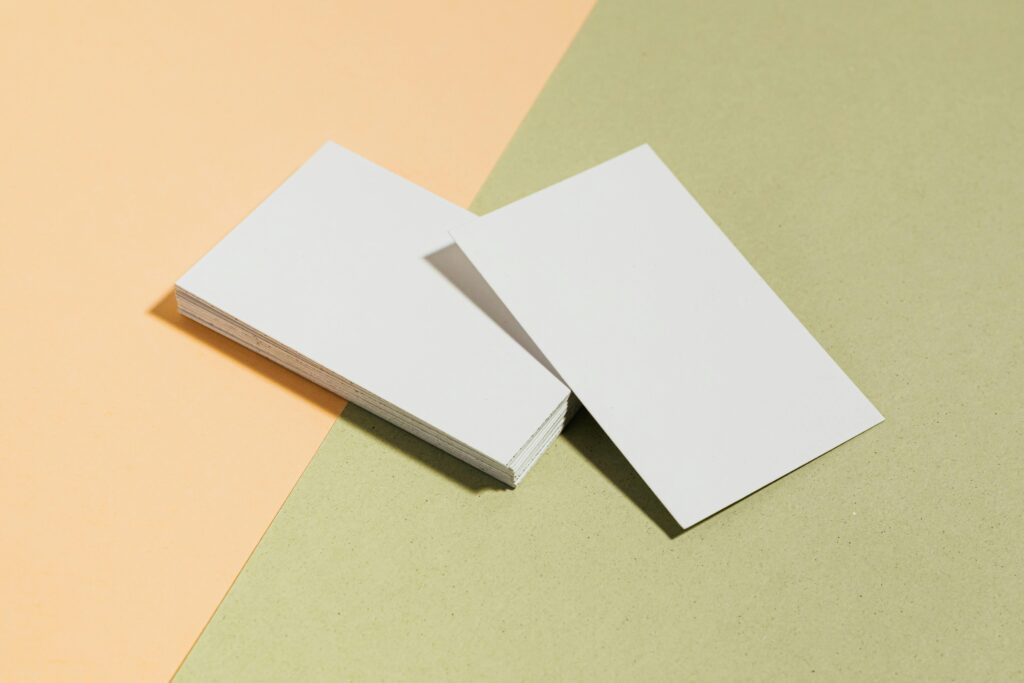 A pair of business cards on top of each other.